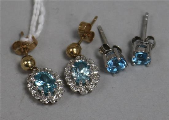 A pair of 9ct gold, blue zircon and diamond cluster earrings and a pair of white metal single stone earrings.